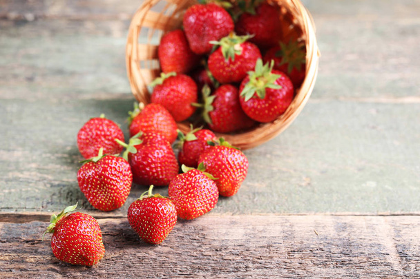 Fresh strawberries on grey wooden table - Фото, изображение