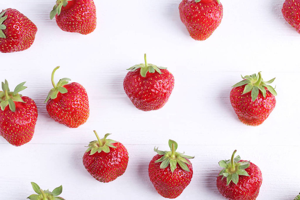 Fresh strawberries on white wooden table - 写真・画像