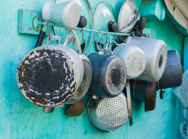 Pots, pans, lids and pots on the wall - Photo, Image