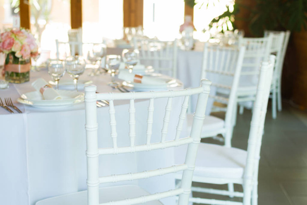 fancy table set for a wedding dinner, white chairs - Photo, Image