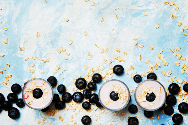 Blueberry yogurt with fraesh berries and oat flakes - Fotó, kép