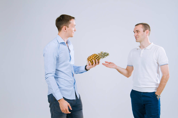 Two guys on a white background hold a deal  - Фото, зображення