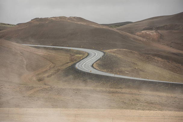 Empty Road leading through the mountain landscape looks like a big symmetric S letter, Iceland. - Photo, image