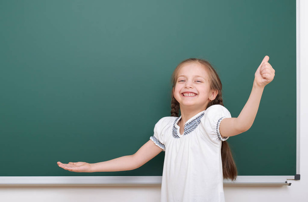 Pupil posing at school board, empty space, education concept - Photo, Image