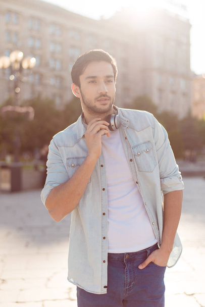 Close up of a young attractive brunete guy, walking in the sprin - Foto, Imagem