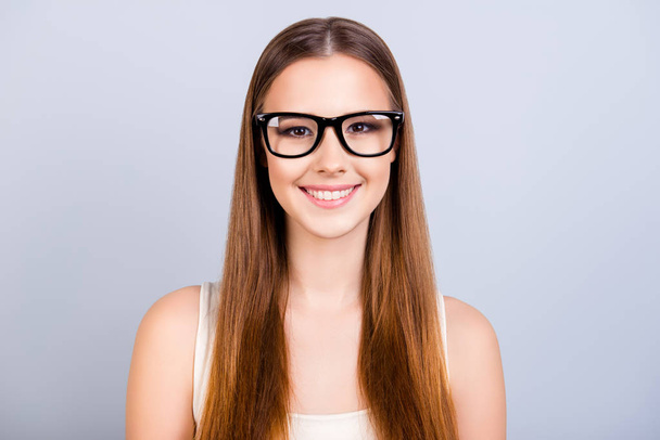 Cute young female student is in a stylish black glasses, wearing - Фото, изображение