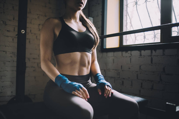 Young woman having some rest after hard workout in gym. - Photo, image