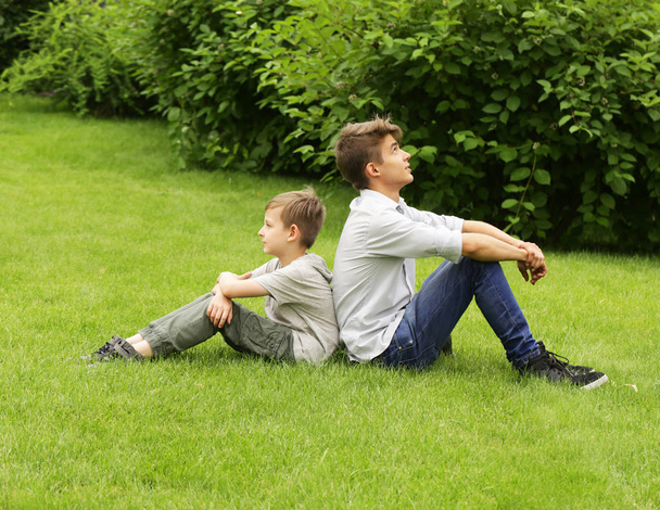 Two brothers have fun in the park - summer time, picnic - Photo, Image
