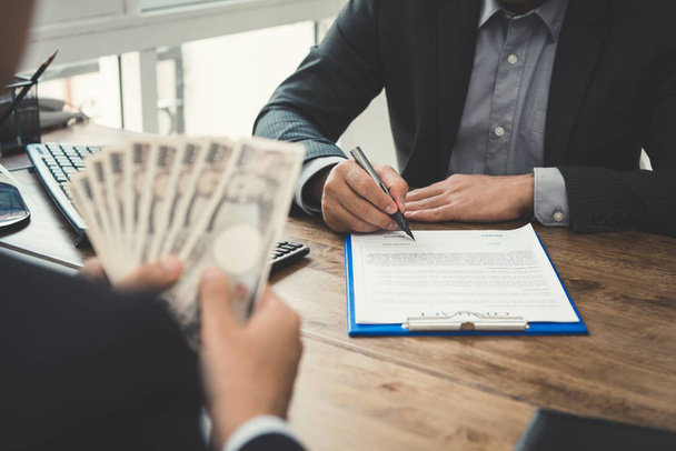 Businessman signing contract on the table - Photo, Image