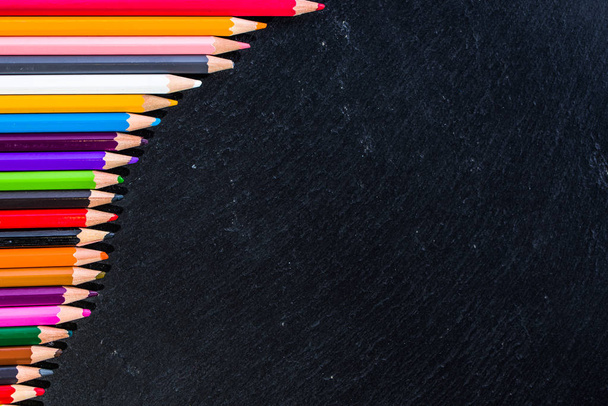 Colored pencils background, frame on black, copy space, back to school concept - Φωτογραφία, εικόνα