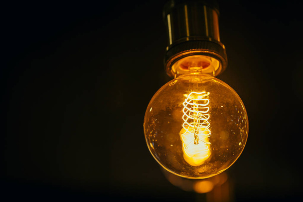 single light bulb on dark background with space for text. - Photo, Image