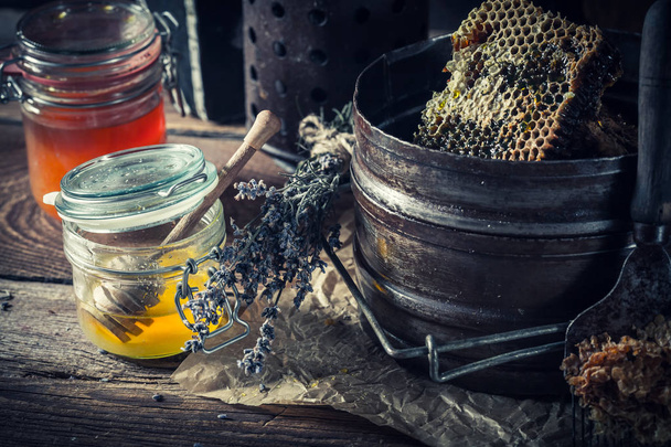 Old beekeeper tools with fresh and sweet honey - Foto, imagen