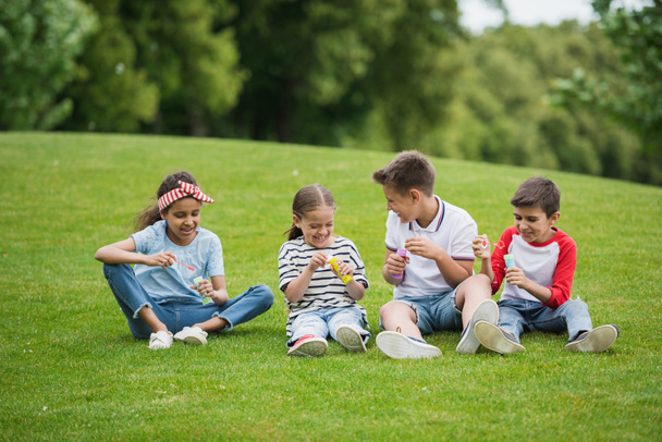 Multiethnic children playing in park - Фото, изображение