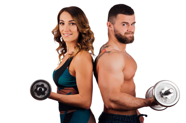 Portrait of a bearded man and girl, fitness model posing on white background. - Foto, afbeelding