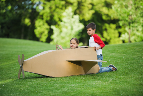 Children playing with toy plane - Foto, imagen