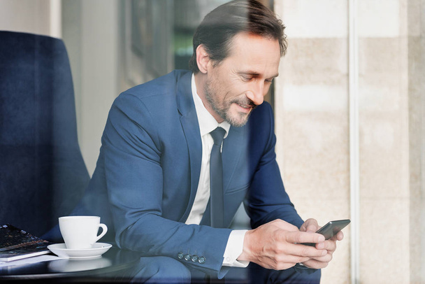 Positive man in suit messaging on cellphone - Photo, Image