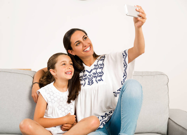 Mom and Daughter making selfie  - Photo, image