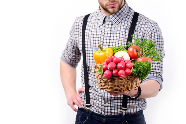 Farmer with fresh radish, tomatoes, parsley, mushrooms and pepper - Photo, image