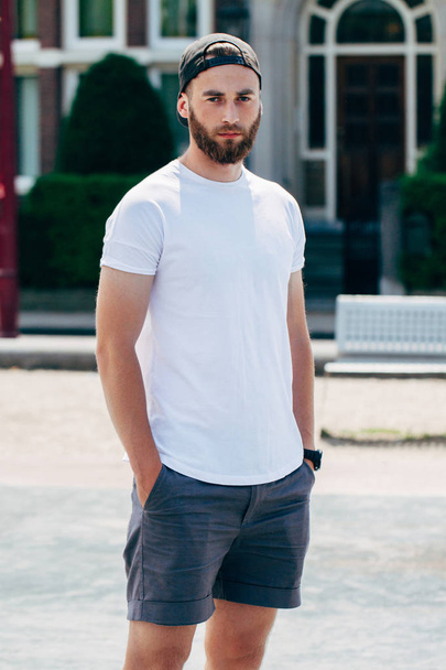 Model with beard  wearing white blank  t-shirt with space for yo - Foto, Imagen