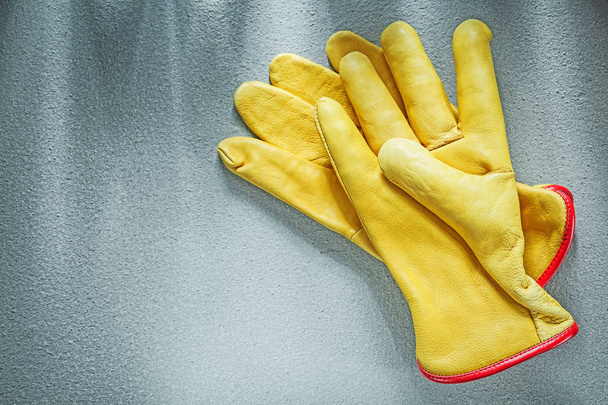 Pair of leather protective gloves on concrete surface constructi - Φωτογραφία, εικόνα