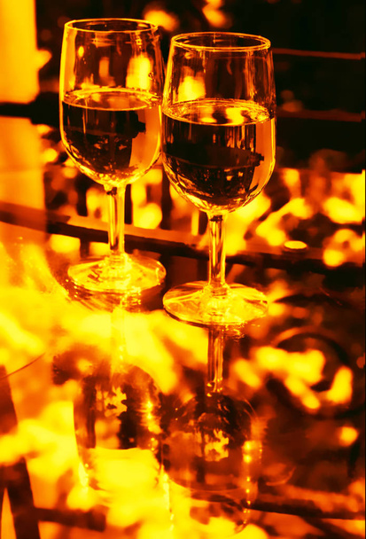 Two glasses of wine in gold tone - Foto, Imagen