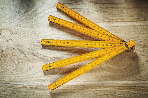 Yellow wooden meter on wood board construction concept - 写真・画像