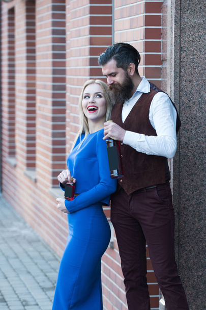 Girl and man smiling with wine and liqueur bottles - Photo, Image