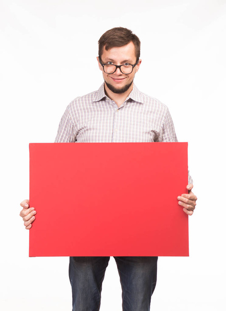 Young happy man showing presentation, pointing on placard - Foto, Imagen