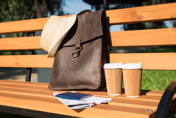 Leather bag and paper cups - Photo, Image