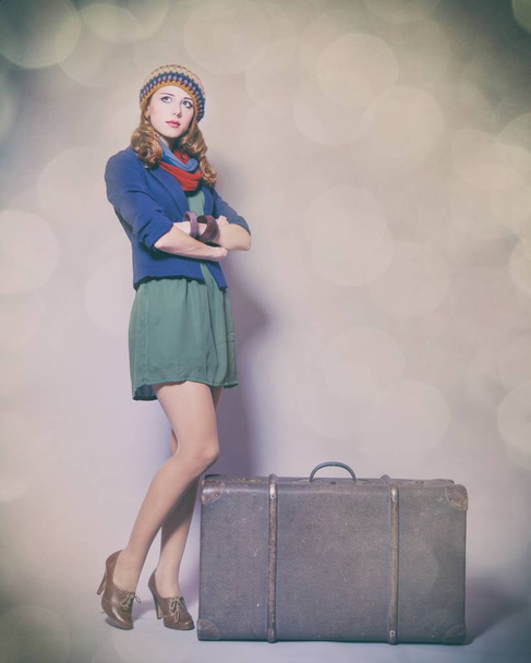  beautiful young woman standing near suitcase  - Фото, изображение