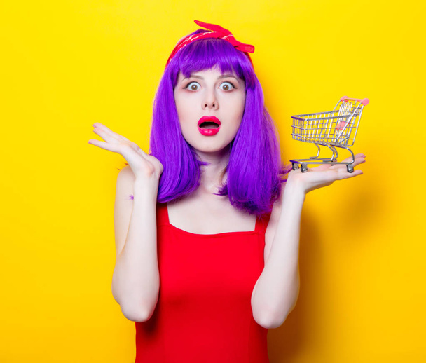 young woman with small supermarket cart  - Photo, Image