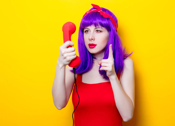 young woman with red handset - Foto, Imagen