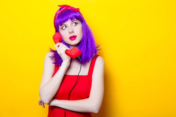 young woman with red handset - Foto, Imagem