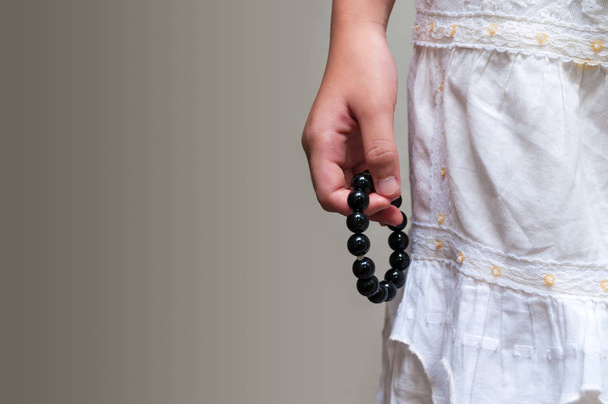 close up stone bead bracelet in girl hand - Photo, Image