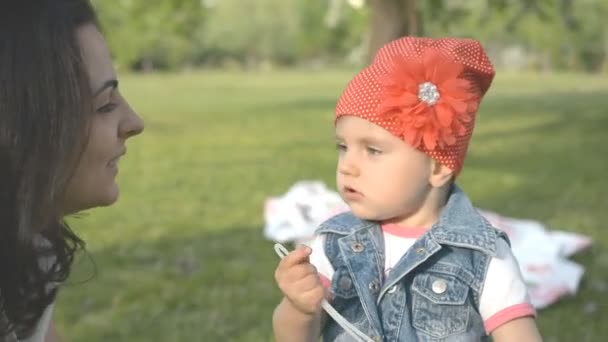 love concept. mom and little daughter kiss in the park - Video