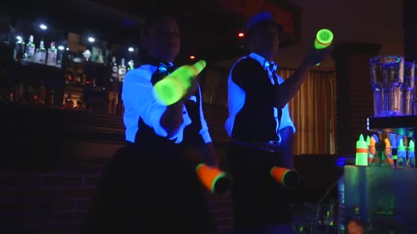 barman show. Two barmen juggle bottles and Beaker for mixing . slow motion - Footage, Video