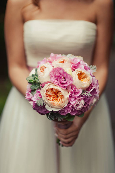 Bride holding big wedding bouquet on wedding ceremony - Photo, image