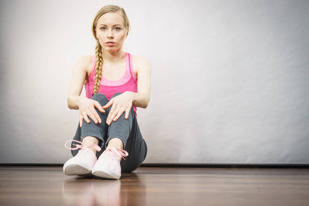 Sad depressed young teenage girl sitting by wall - Photo, image