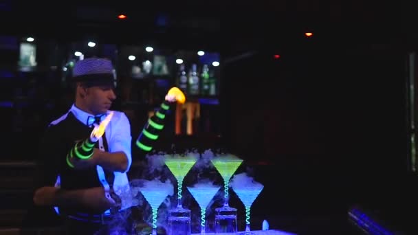 Male bartender juggling bottle with fire. Barman show, clear shots, man professional bartender - Footage, Video