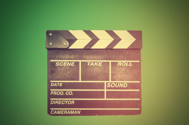 Filming, movie clapperboard on green - Foto, Bild