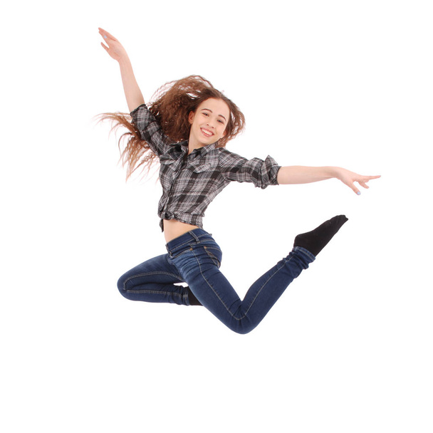 The girl is jumping and smiling. - Φωτογραφία, εικόνα