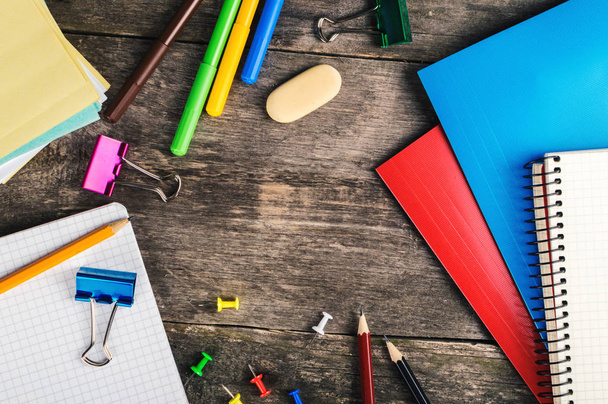 Frame of school supplies on wooden background. Top view - 写真・画像
