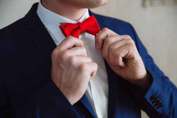 Man holding red bow tie. Elegant gentleman clother. - Foto, Imagem