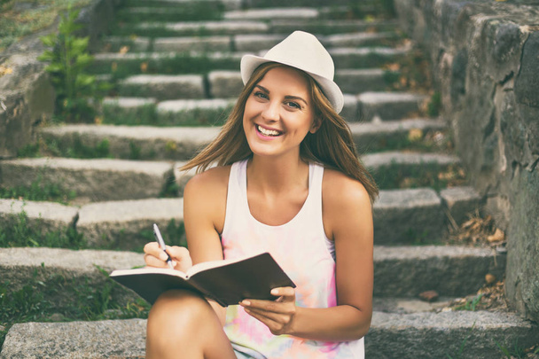 Young woman  writing in her notebook  - Foto, Imagem