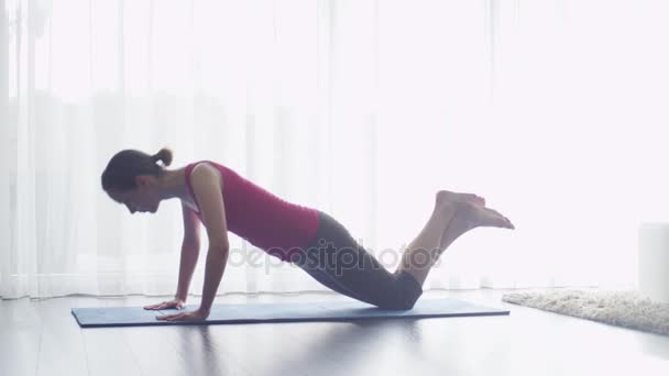 Young Woman doing Fitness in Living Room at Home - Filmati, video