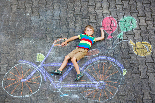 little kid boy having fun with bicycle chalks picture on ground - Photo, Image