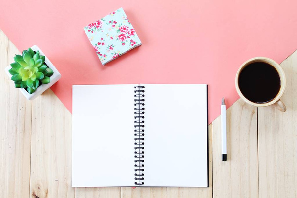 Top view image of open notebook with blank pages, accessories and coffee cup on wooden background, ready for adding or mock up - Photo, Image