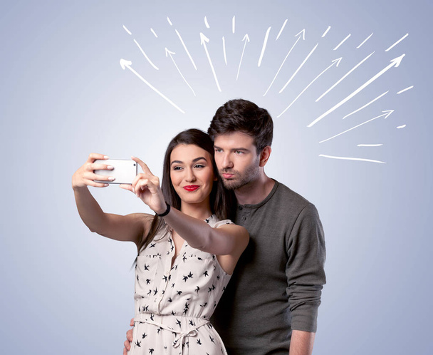 Cute couple taking selfie with arrows - Foto, Bild
