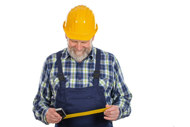 Elderly builder holding utensils - Fotoğraf, Görsel