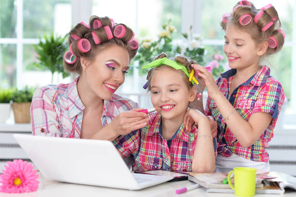 mother and daughters making hairstyles - Photo, Image